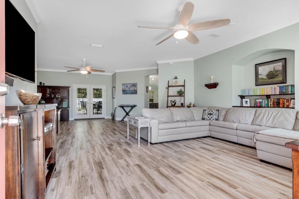 The spacious great room, with double French doors opening onto the lanai, is ideal for family living and entertaining.