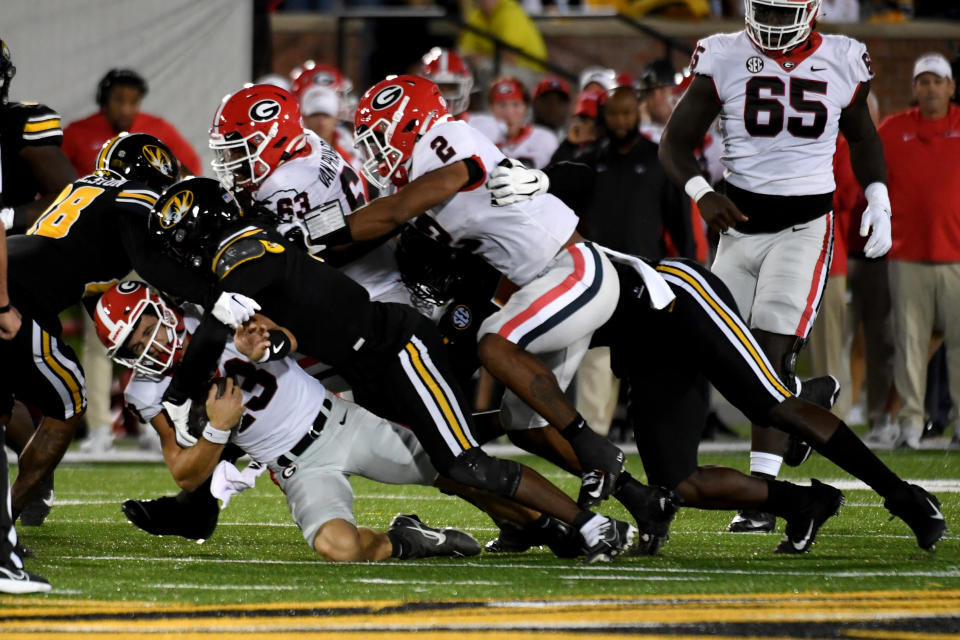 Georgia quarterback Stetson Bennett (13) is sacked by a host of Missouri defenders during the first half of an NCAA college football game Saturday, Oct. 1, 2022, in Columbia, Mo. (AP Photo/L.G. Patterson)