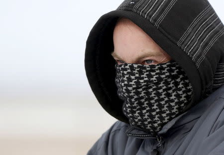 A militiaman stands on a road at the Malheur National Wildlife Refuge near Burns, Oregon, January 4, 2016. REUTERS/Jim Urquhart