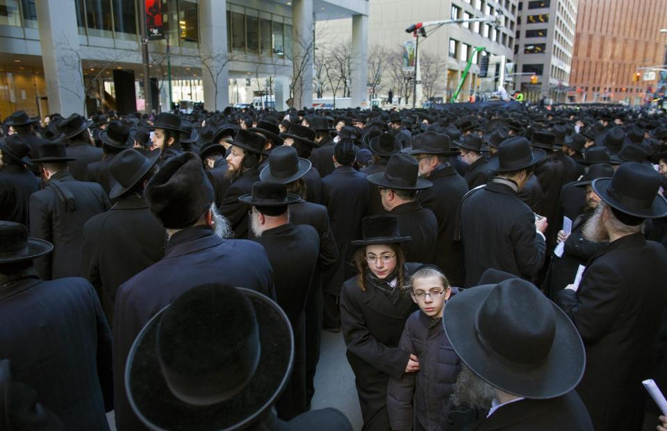 Thousands of Orthodox Jews gather in New York, Sunday, March 9, 2014, on Water Street in lower Manhattan, to pray and protest against the Israeli government's proposal to pass a law that would draft strictly religious citizens into its army. (AP Photo/Craig Ruttle)