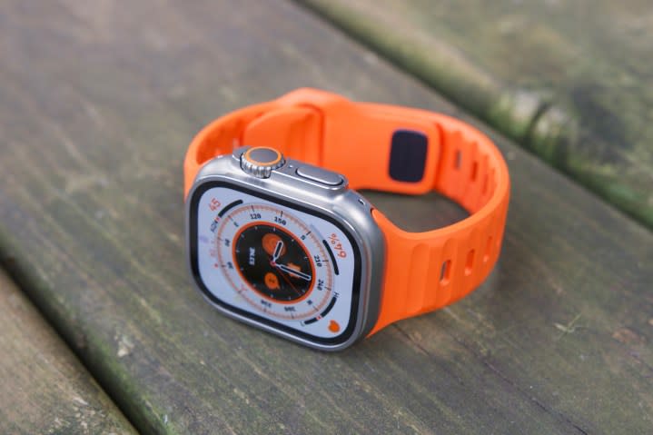 Overhead view of an Apple Watch Ultra resting on a wooden patio.