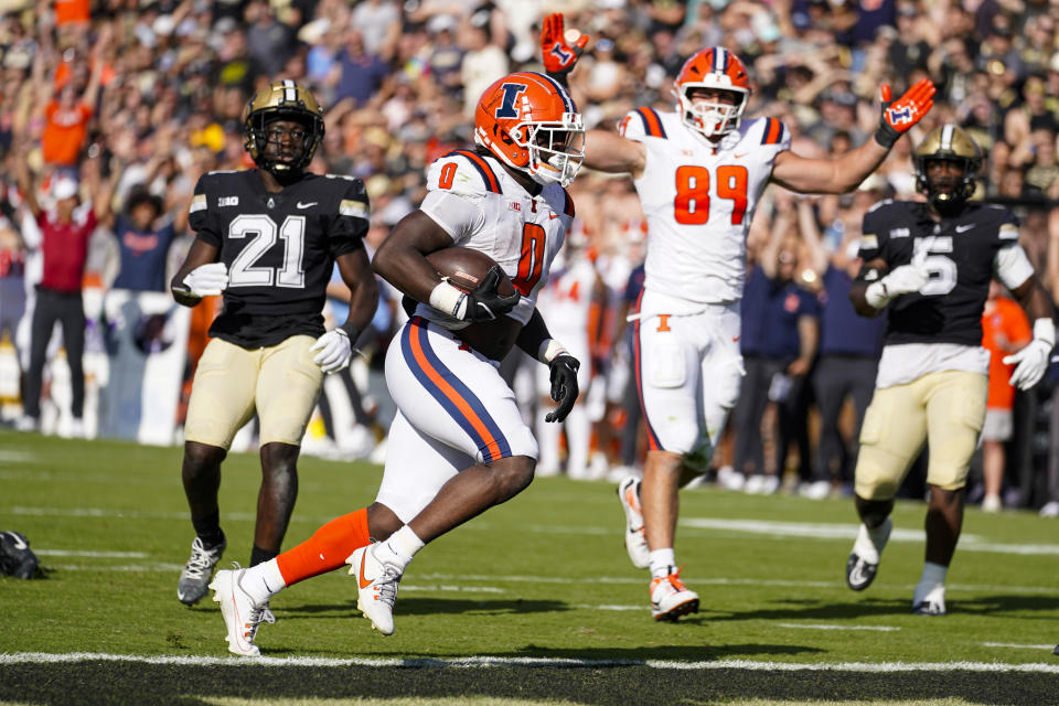 Illinois running back Josh McCray (0) runs in for a touchdown against Purdue during the first half of an NCAA college football game in West Lafayette, Ind., Saturday, Sept. 30, 2023. (AP Photo/Michael Conroy)