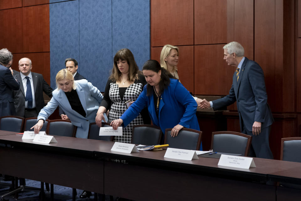 From left, Ukrainian Parliament members Yevheniya Kravchuk and Lesia Zaburanna, Ukrainian Amb. Oksana Markarova, U.S. Sen. Rob Portman, R-Ohio, Ukraine Parliament member Maria Ionova, and Sen. Rob Portman, R-Ohio, arrive to discuss the ongoing Russian invasion of Ukraine, at the Capitol in Washington, Wednesday, March 30, 2022. (AP Photo/J. Scott Applewhite)