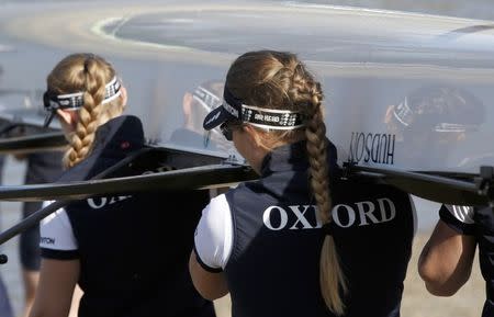 Members of the Oxford women's crew prepare to take to the water before the Oxford versus Cambridge University boat race on the Thames in London, April 11. 2015. REUTERS/Peter Nicholls