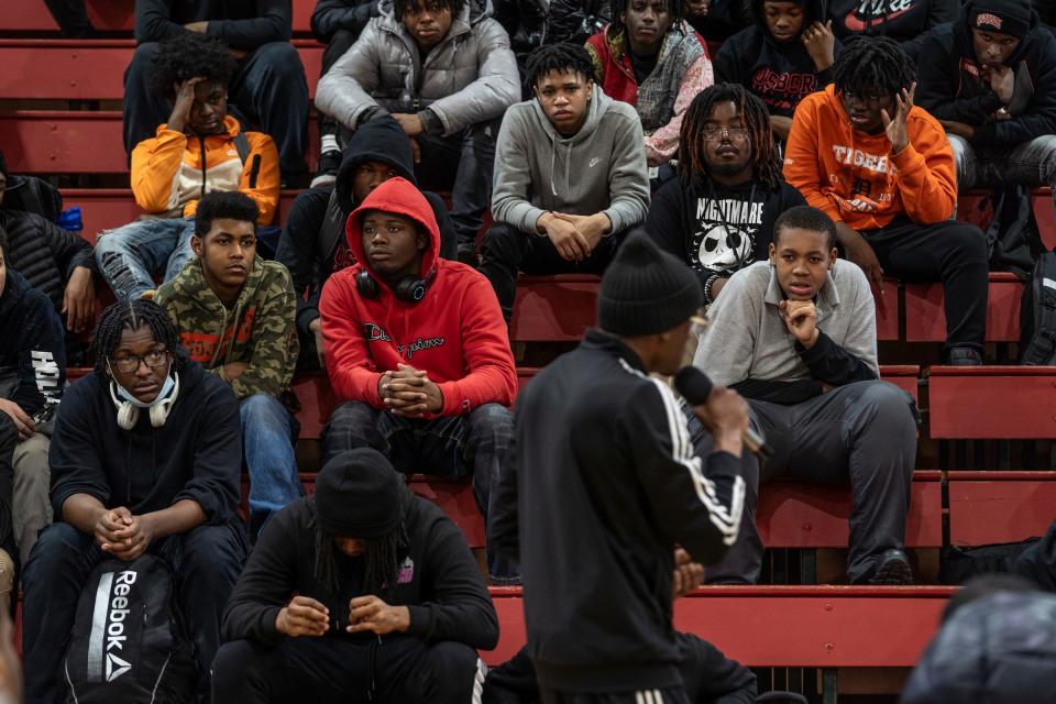 Osborn High School students listen as David Daniels, 43, of Detroit, a member of the 5s from the Red Zone, as rival gang members from the 4s and 5s unite to preach peace and an end to violence in the aftermath of the killing of 11-year-old Latrelle Mines in early January during an assembly at Osborn High School on Friday, Feb. 2, 2023.