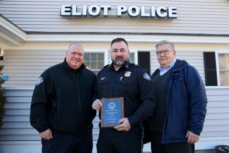 Eliot police Sgt. Ronald Lund, left, Police Chief Elliott Moya and Town Manager Michael Sullivan celebrate Tuesday, Jan. 31, 2023, after Moya was named Maine Chief of the Year.