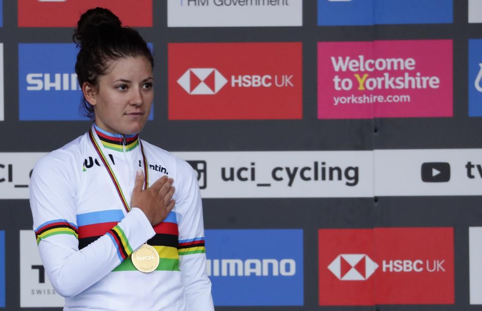 FILE - United States' Chloe Dygert listens to the national anthem on the podium after winning the women's elite individual time trial event at the road cycling World Championships in Harrogate, England, Tuesday, Sept. 24, 2019. (AP Photo/Manu Fernandez, File)