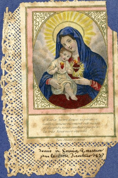 A holy card depicting the Virgin Mary holding infant Jesus with Sacred Heart