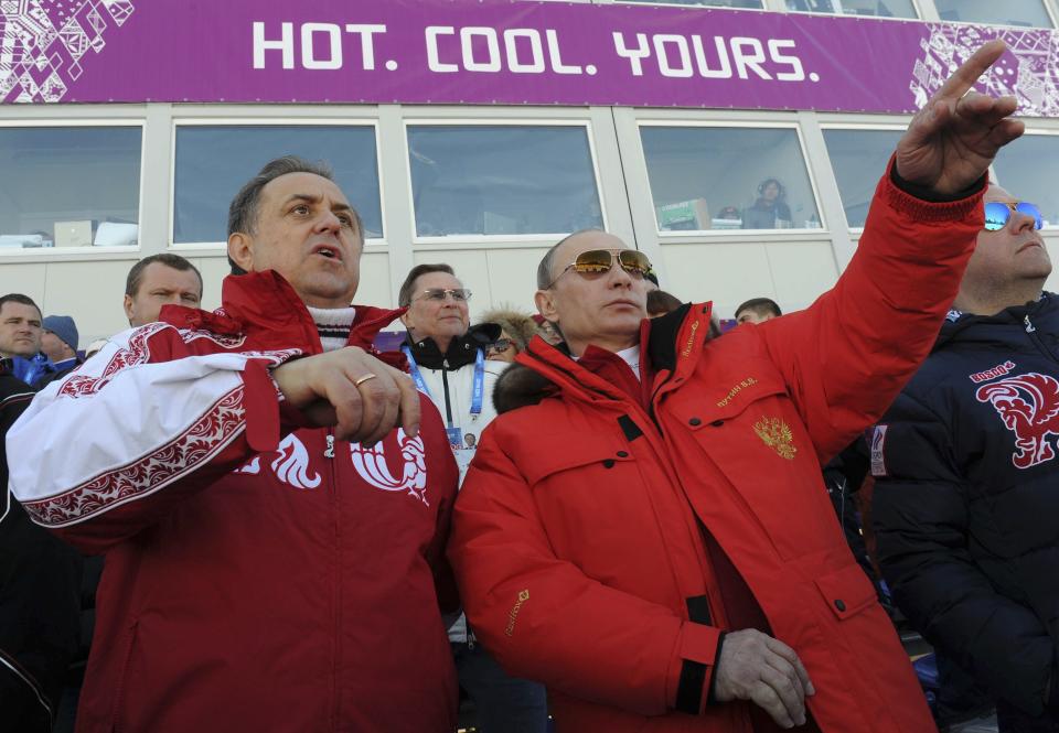 Russian President Putin and Sports Minister Mutko watch the cross country skiing men's relay during the Sochi 2014 Olympic Winter Games at Laura Cross-Country Ski and Biathlon Center near Krasnaya Polyana