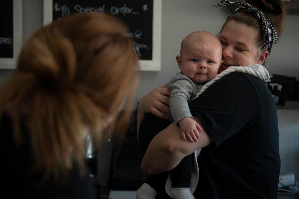 Ashley Corbetta holds son Luca Corbetta, 4 months old, while talking to front-of-house manager Kendra Walker at Bea Sweet Treats in Newburgh, Ind., Tuesday afternoon, March 15, 2022. Corbetta opened the bakery with her mother, Stephanie Post, about two weeks after Luca was born in December of 2021. 