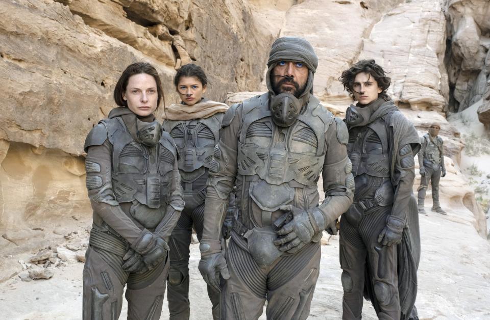 Timothée Chalamet, Zendaya, and other cast members in uniform against a rocky backdrop