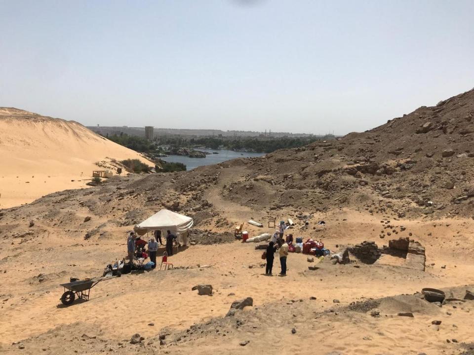 Several people in and under a white tent in Aswan, Egypt