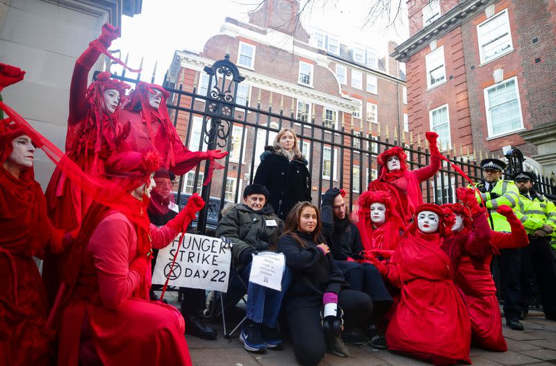 Model Lily Cole stands amongst hunger strikers and an Extinction Rebellion environmental activist action group, known as The Red Brigade