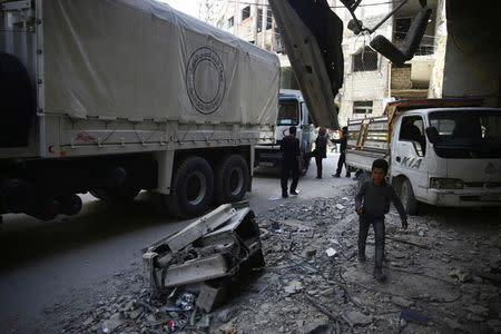 People are seen around Red Crescent aid truck in the besieged town of Douma, Eastern Ghouta, in Damascus, Syria March 9, 2018. REUTERS/ Bassam Khabieh