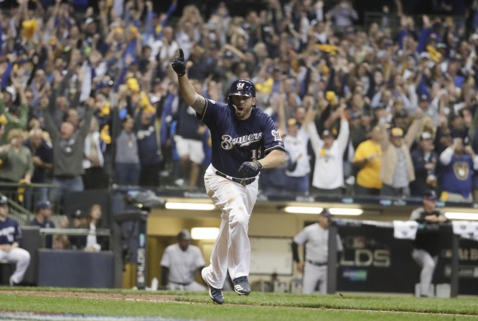 Milwaukee Brewers' Mike Moustakas hits a walk off RBI single during the 10th inning of Game 1 of the National League Divisional Series baseball game against the Colorado Rockies Thursday, Oct. 4, 2018, in Milwaukee. The Brewers won 3-2 to take a 1-0 lead in the series. (AP Photo/Morry Gash)