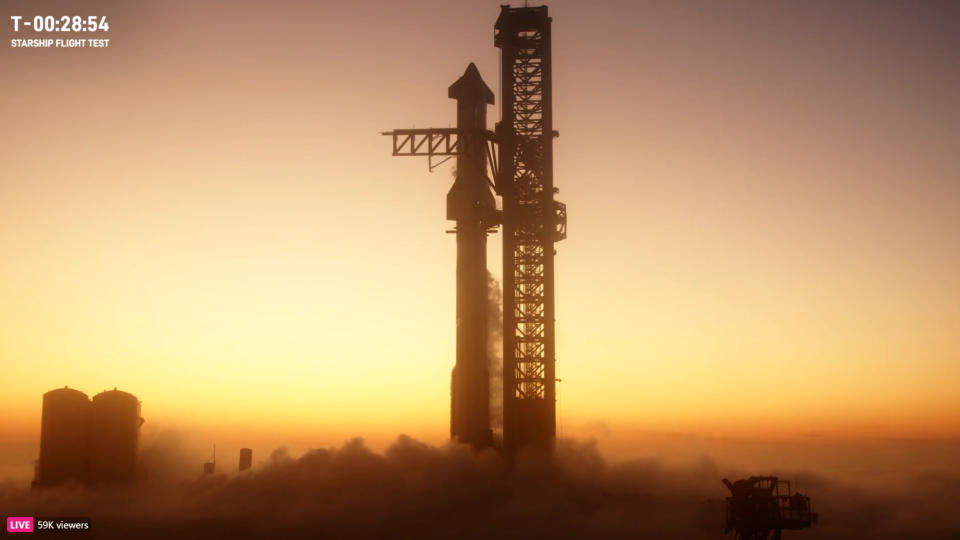 SpaceX Starship at sunrise surrounded by vapor during launch fueling
