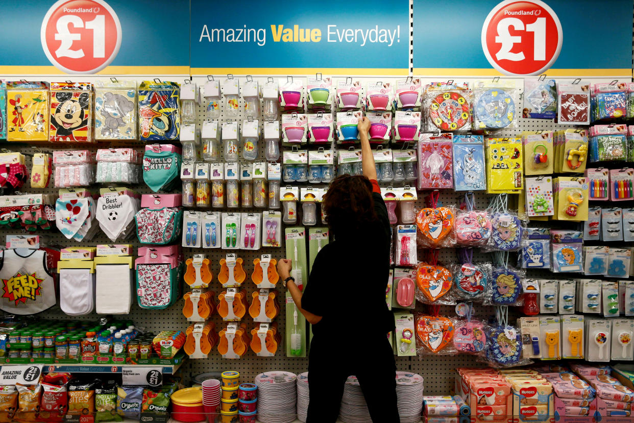 A Poundland employee checks products in a store in London, Britain November 10, 2015. REUTERS/Stefan Wermuth/File Photo 