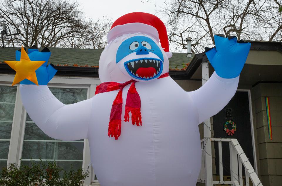 The weather may be as abominable as this inflatable snowman seen in a Eugene front yard as a weather front brings cold air and moisture to the Willamette Valley for the holidays. 