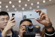 People take photos of the new iPhone 11 Pro in the demonstration room at an Apple event at their headquarters in Cupertino