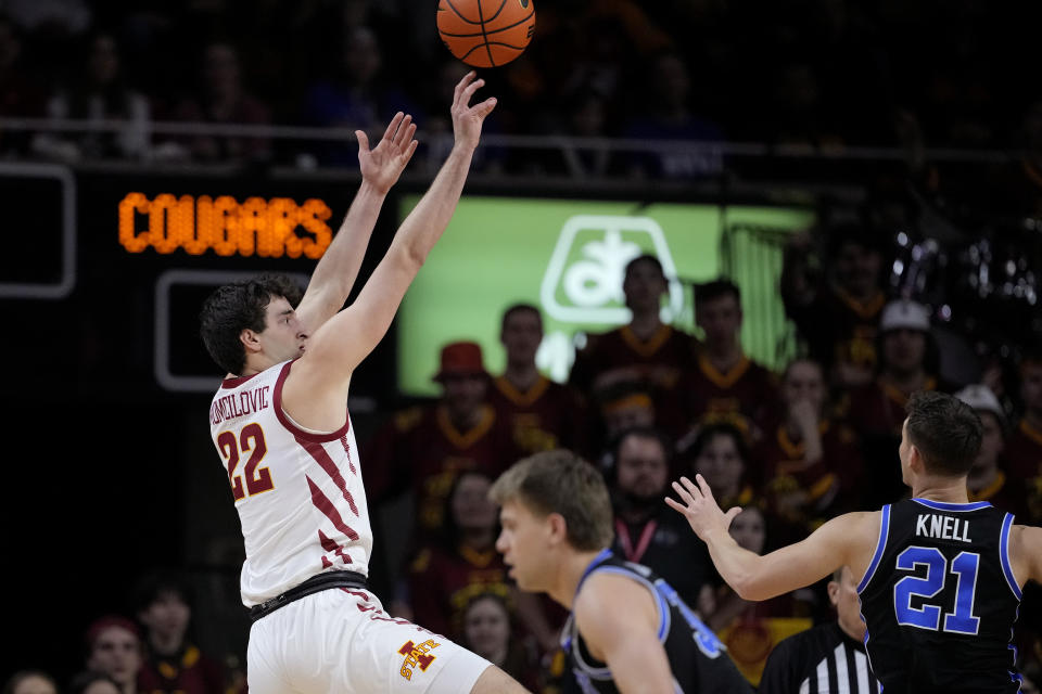 Iowa State forward Milan Momcilovic (22) shoots over BYU guard Trevin Knell (21) during the first half of an NCAA college basketball game Wednesday, March 6, 2024, in Ames, Iowa. (AP Photo/Matthew Putney)