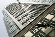 FILE PHOTO: Japanese pole-vaulter Takehito Ariki tries to clear a bar between two Tokyo skyscrapers during a street track and field event at the Marunouchi business district in Tokyo