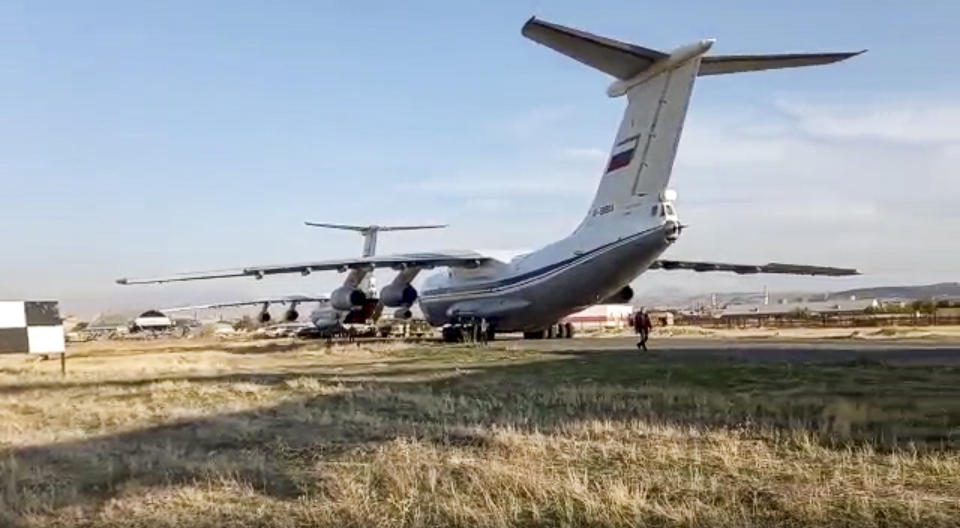 This photo taken from the footage provided by Russian Defense Ministry press service on Tuesday, Nov. 10, 2020 shows Russian military planes with peacekeepers on boards after landing at Erebuni Airport outside Yerevan, Armenia. More than a dozen planes carrying Russian peacekeepers headed for Nagorno-Karabakh on Tuesday, hours after Armenia and Azerbaijan agreed to halt fighting over the separatist region and amid signs this cease-fire would hold where others hadn't. (Russian Defense Ministry Press Service via AP)