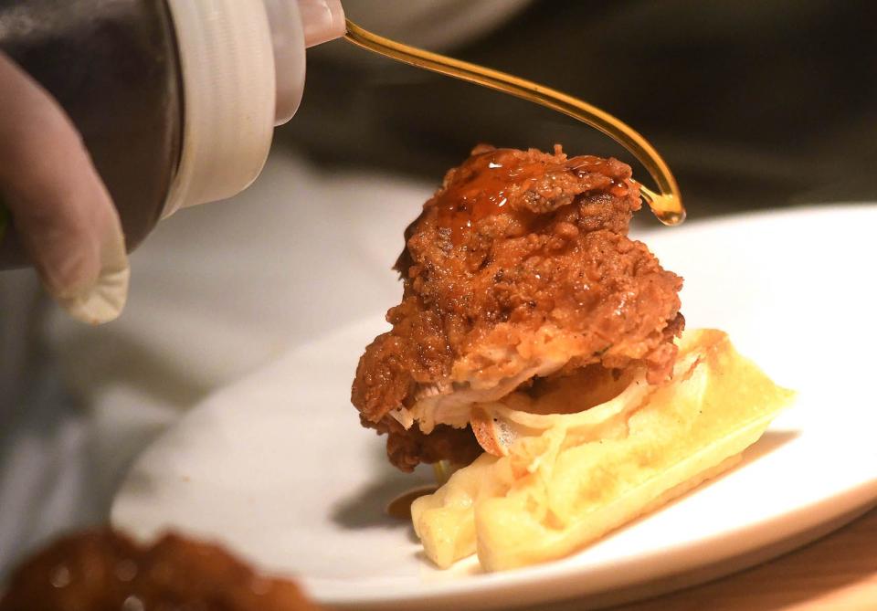 Emeril's chicken and waffles were one of the dishes Celebrity chefs Emeril Lagasse and Rachael Ray served as they helped to host a gourmet breakfast and a four-course luncheon on February 10, 2023 at the Landfall Country Club for a GLOW Fundraiser.