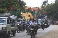 Supporters of the military-backed Union Solidarity and Development Party (USDP) wave the party flags while riding their motorbikes and decorated cars during an election campaign for next month's general election, Thursday, Oct. 1, 2020, in Naypyitaw, Myanmar. (AP Photo/Aung Shine Oo)