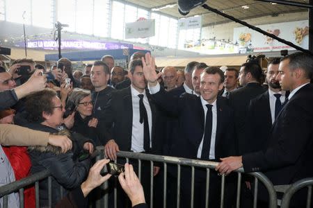 French President Emmanuel Macron waves as he visits the International Agriculture Fair (Salon de l'Agriculture) at the Porte de Versailles exhibition centre in Paris, France, February 23, 2019. Ludovic Marin/Pool via Reuters