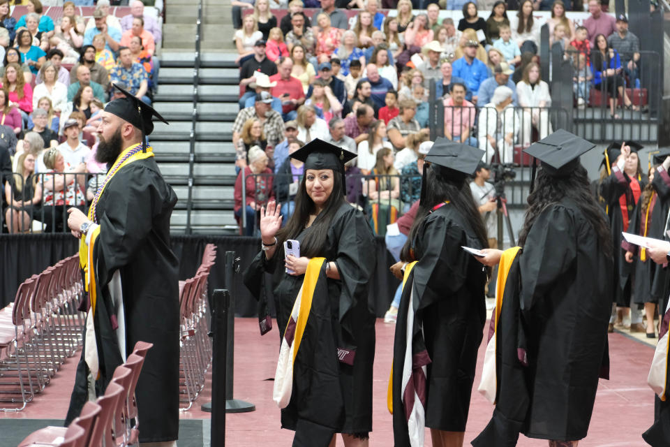 A graduate waves at the crowd Saturday at the WT Commencement Ceremony in Canyon.