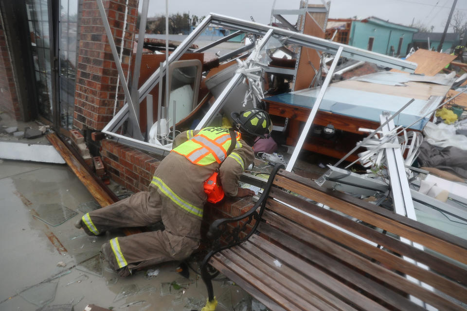 <p>A Rockport firefighter goes door to door on a search and rescue mission as he looks for people that may need help after Hurricane Harvey passed through on August 26, 2017 in Rockport, Texas. (Photo: Joe Raedle/Getty Images) </p>