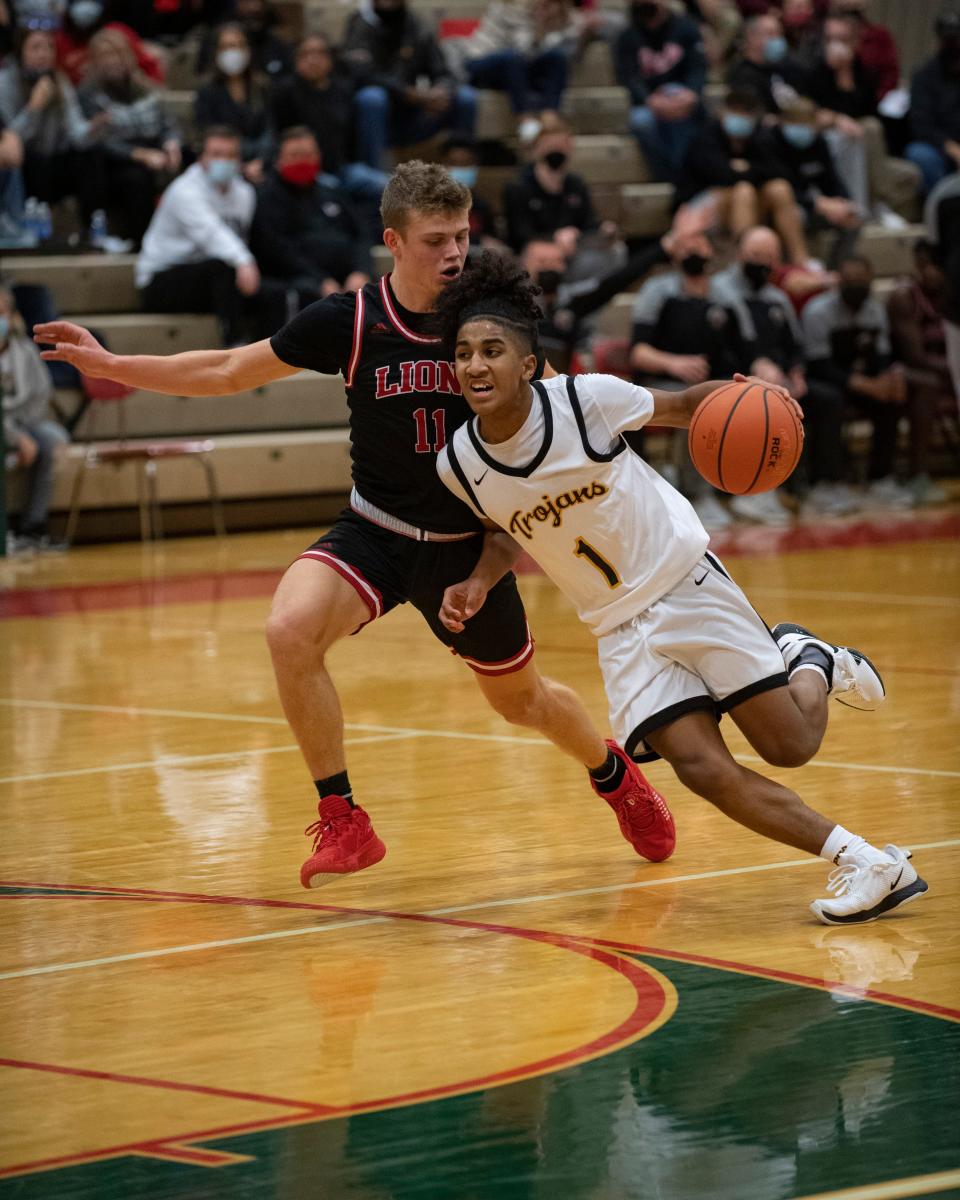 Topeka High guard Isaiah Lyons (1) drives for the basket Friday.