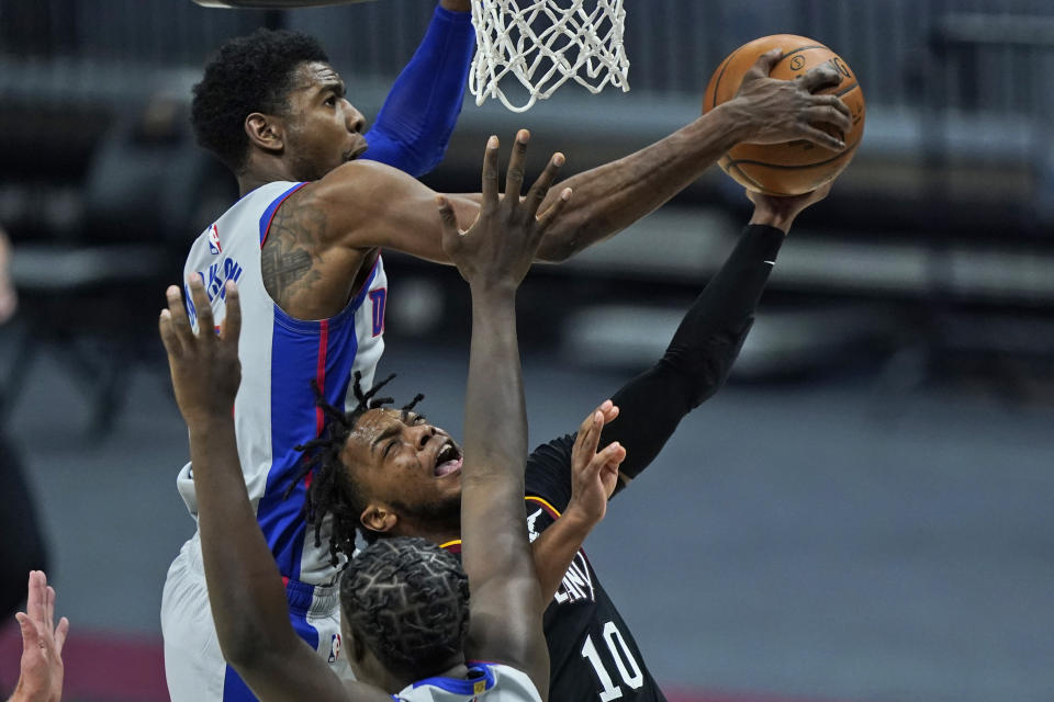 Cleveland Cavaliers' Darius Garland (10) drives to the basket as Detroit Pistons' Josh Jackson (20) knocks the ball loose in the first half of an NBA basketball game, Wednesday, Jan. 27, 2021, in Cleveland. (AP Photo/Tony Dejak)