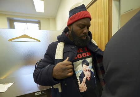 The father, Michael Brown Sr., of slain teenager Michael Brown, arrives for a news conference in Geneva November 12, 2014. REUTERS/Denis Balibouse