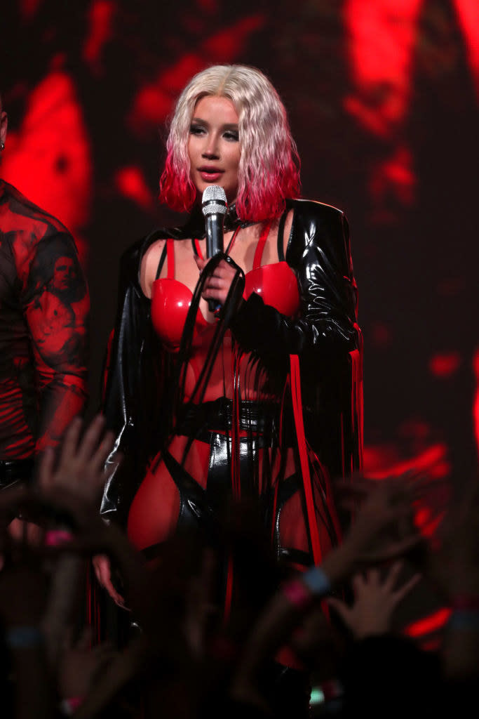 Iggy Azalea in a red and black outfit on stage