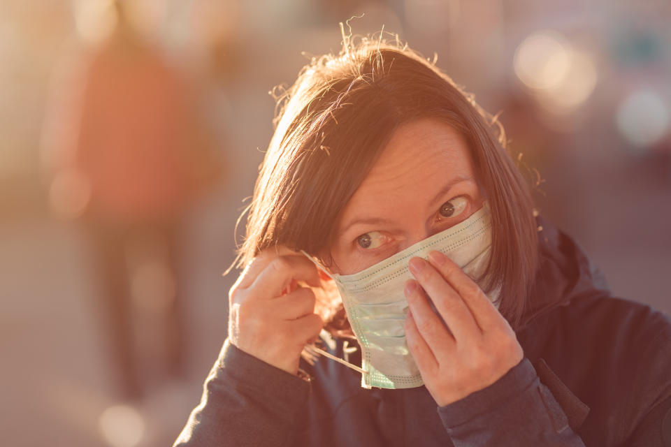 Do not touch the front of your mask with your hands after using one, because the front of the mask could be contaminated. (Photo: stevanovicigor via Getty Images)