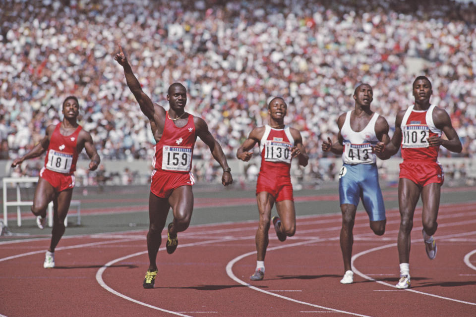 Canada sprinter Ben Johnson (second from left) celebrates winning the men's 100m in world-record time at the 1988 Seoul Olympics. He would later be disqualified for taking performance-enhancing drugs.