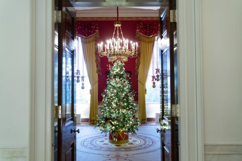 FILE - The Red Room of the White House is decorated for the holiday season during a press preview of the White House holiday decorations, Nov. 29, 2021, in Washington. In addition to fewer people passing through the White House for the open houses, thousands of other people didn't get a close-up look at how Jill Biden decked out White House hallways and public rooms for the holidays because public tours of the executive mansion remain on indefinite hold due to COVID-19. (AP Photo/Evan Vucci, File)