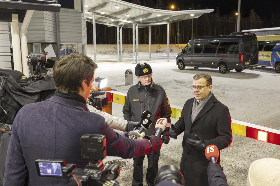 Chief of the Finnish Border Guard, Lieutenant General Pasi Kostamovaara, left, looks on as Finnish Prime Minister Petteri Orpo speaks at a press briefing as he visited the Vartius border crossing station in Kuhmo, Eastern Finland, Monday, Nov. 20, 2023. Finland’s prime minister says the country may need to take further actions on its border with Russia after closing four border crossings in an attempt to stem a recent increase in asylum-seekers. (Hannu Huttu/Lehtikuva via AP)