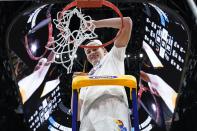 Kansas' Mitch Lightfoot cuts down the net after a college basketball game in the Elite 8 round of the NCAA tournament Sunday, March 27, 2022, in Chicago. Kansas won 76-50 to advance to the Final Four. (AP Photo/Nam Y. Huh)