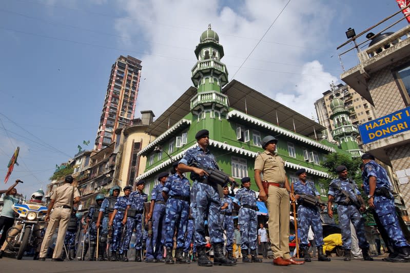 Rapid Action Force personnel stand guard outside a mosque before Supreme Court's verdict on a disputed religious site in Ayodhya, in Mumbai