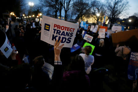 FILE PHOTO - Transgender activists and supporters protest the Trump administration's decision to revoke Obama administration guidance that allowed transgender public school students to use the bathroom of their choice, near the White House in Washington, U.S. on February 22, 2017. REUTERS/Jonathan Ernst/File Photo