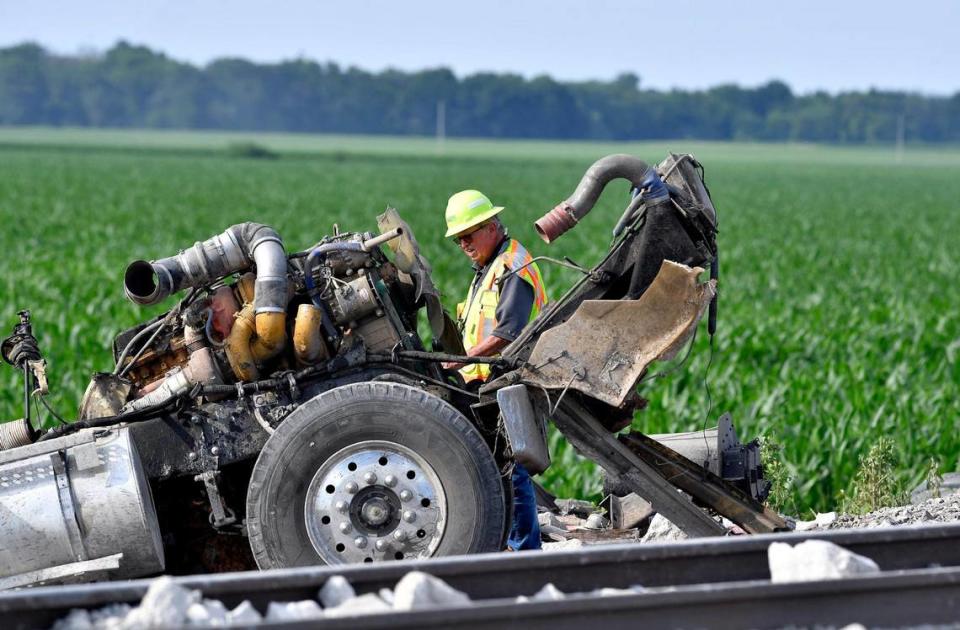 An investigator gathered notes at the intersection where parts of a truck came to rest after an Amtrak crashed into it near Mendon, Missouri.