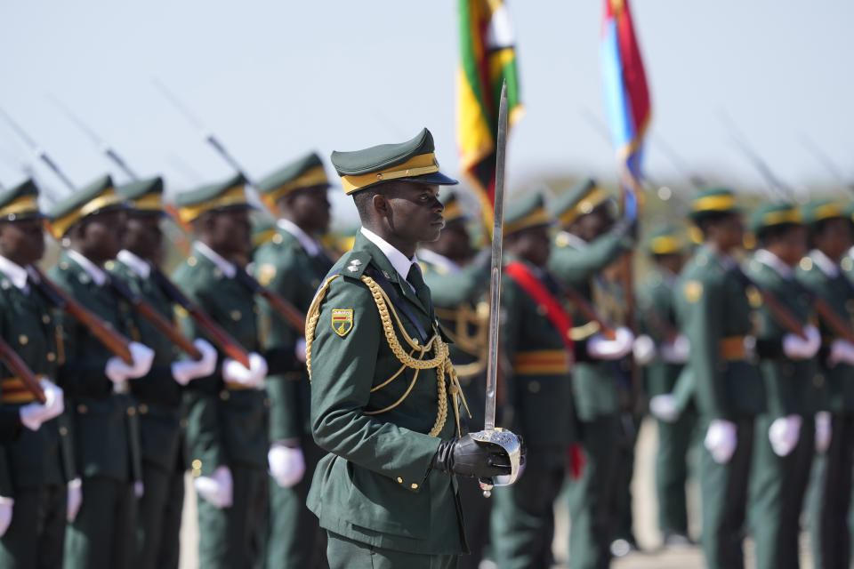 Zimbabwean soldiers stand guard as Iran's President Ebrahim Raisi inspects the guard of honour upon his arrival at Robert Mugabe airport in Harare, Zimbabwe, Thursday, July 13, 2023. Iran's president is on a rare visit to Africa as the country, which is under heavy U.S. economic sanctions, seeks to deepen partnerships around the world. (AP Photo/Tsvangirayi Mukwazhi)