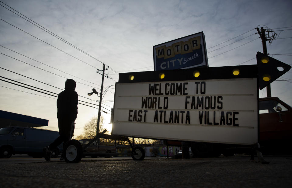 A sign greets drivers outside a shop in East Atlanta, Ga., in Dekalb County, Monday, Jan. 9, 2017. As Donald Trump prepares to enter the Oval Office, citizens with disparate views from urban and rural areas illustrate widening cultural fissures that help explain Trump's rise and will define his presidency. (AP Photo/David Goldman)