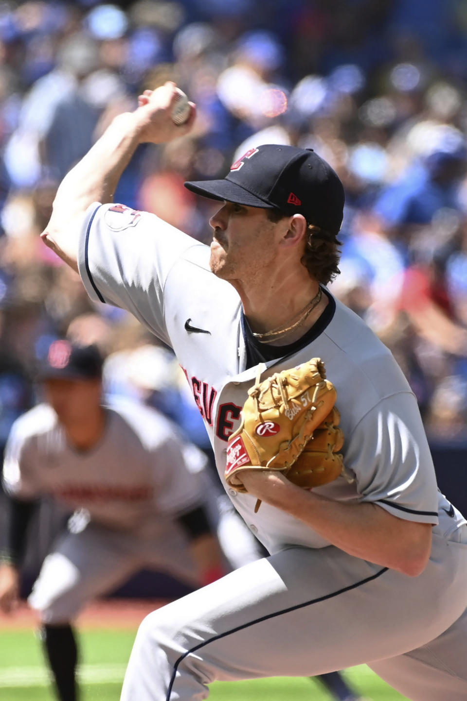 Cleveland Guardians starting pitcher Shane Bieber throws to a Toronto Blue Jays batter in the first inning of a baseball game in Toronto, Sunday, Aug. 14, 2022. (Jon Blacker/The Canadian Press via AP)