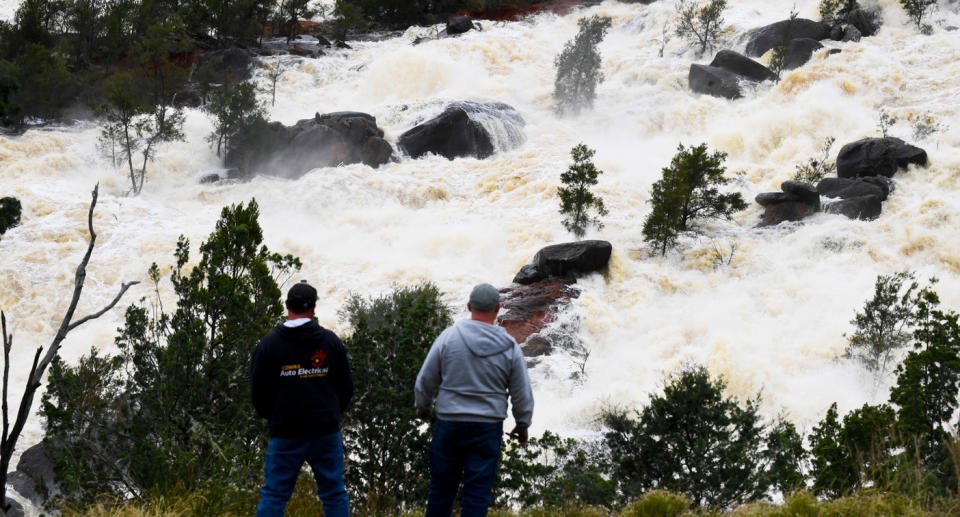 Locals take a look at overflow water spills from Wyangala Dam near the NSW town of Cowra, Monday, November 15, 2021.