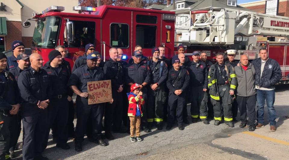 Elliott Slocum stands with Wilmington firefighters as they welcome him.