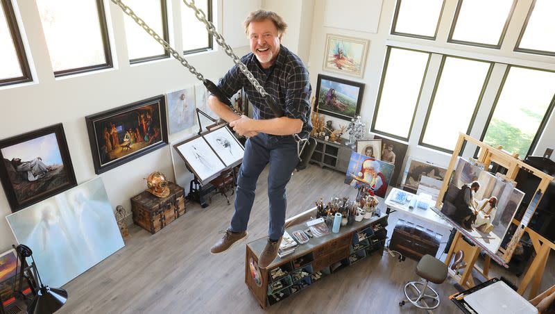 Artist Greg Olsen poses for a portrait on a swing in his home studio in Heber on Monday, Oct. 9, 2023.