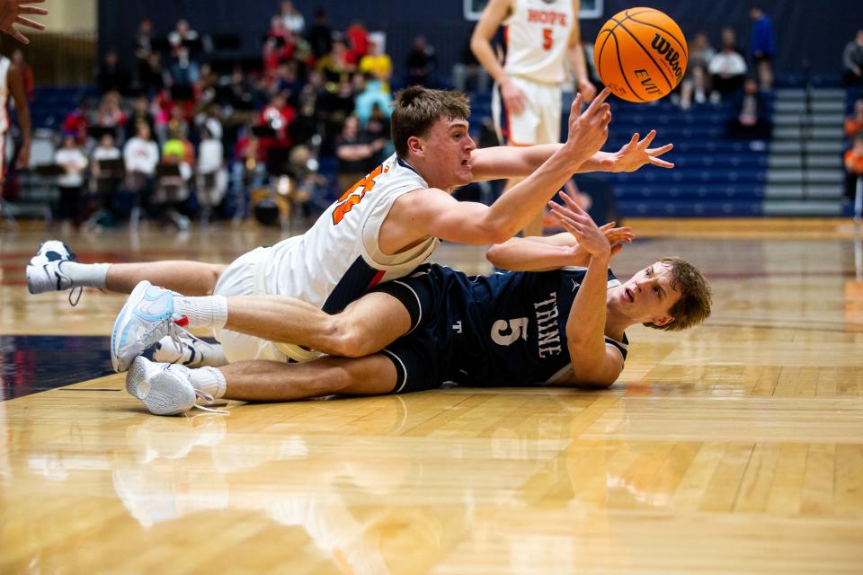 Hope's Gabe Quillan reaches for a loose ball during a game against Trine Wednesday, Feb. 8, 2023, at DeVos Fieldhouse. 